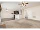 Open-concept living room and kitchen with stainless steel appliances and dark wood cabinets at 1205 Heartwood Ave, Mcdonough, GA 30253