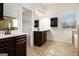 A spacious main bathroom with double sinks, dark wood cabinetry and tiled floors at 1205 Heartwood Ave, Mcdonough, GA 30253