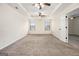 A large, carpeted main bedroom with multiple ceiling fans and windows for ample natural light at 1205 Heartwood Ave, Mcdonough, GA 30253