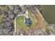 An aerial view of a meticulously landscaped property, highlighting its lush lawn, winding driveway, and lakefront location at 459 Lester Rd, Fayetteville, GA 30215