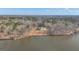 Aerial shot of the secluded lakeside property with expansive surrounding woods, docks, and stunning views from all sides at 459 Lester Rd, Fayetteville, GA 30215