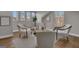 Cozy sitting room features neutral paint, hardwood floors, and natural light from windows in attic space at 459 Lester Rd, Fayetteville, GA 30215