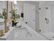 Modern bathroom with marble countertops, glass shower and elegant gold fixtures at 459 Lester Rd, Fayetteville, GA 30215