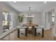 Bright dining room features a modern chandelier, round table, and a large window with a backyard view at 459 Lester Rd, Fayetteville, GA 30215