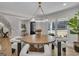 Bright dining room features a modern chandelier, round table, and a large window with a front yard view at 459 Lester Rd, Fayetteville, GA 30215