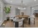 Bright dining room features a modern chandelier, round table, and sleek decor at 459 Lester Rd, Fayetteville, GA 30215
