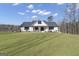 Beautifully landscaped front yard showcasing the home's modern farmhouse design at 459 Lester Rd, Fayetteville, GA 30215