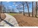 A beautifully landscaped yard and circular drive leading to a home situated near a scenic lake at 459 Lester Rd, Fayetteville, GA 30215