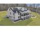 Stunning exterior view of the home featuring multiple decks, a spacious yard, and a convenient garage entrance at 459 Lester Rd, Fayetteville, GA 30215
