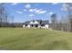 Well-manicured lawn leads to a charming modern farmhouse at 459 Lester Rd, Fayetteville, GA 30215