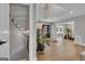 Bright foyer featuring a unique staircase, hardwood floors, a black front door, and a glimpse of the dining room at 459 Lester Rd, Fayetteville, GA 30215