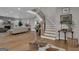 Inviting foyer with hardwood floors, curved staircase, and open floor plan at 459 Lester Rd, Fayetteville, GA 30215