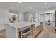 Kitchen island with white marble countertops, stainless steel appliances, and a dining area nearby at 459 Lester Rd, Fayetteville, GA 30215