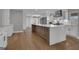 Spacious kitchen with a large center island featuring sleek countertops and stylish cabinetry and fixtures at 459 Lester Rd, Fayetteville, GA 30215