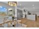 Open-concept kitchen and dining area boasts an island, modern appliances, and a scenic lake view at 459 Lester Rd, Fayetteville, GA 30215