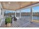 Relaxing outdoor living space with plush seating, wood ceiling, and scenic views of the lake at 459 Lester Rd, Fayetteville, GA 30215