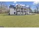 Expansive rear exterior view showcasing dual decks overlooking the lush backyard and wooded landscape at 459 Lester Rd, Fayetteville, GA 30215