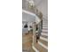 Elegant staircase with wooden treads, white risers, black iron railings, and views into the living area at 459 Lester Rd, Fayetteville, GA 30215