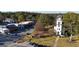 Aerial view of a town center with shops, a clock tower, and tree-lined streets at 459 Lester Rd, Fayetteville, GA 30215