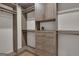 Organized walk-in closet features custom shelving and drawers with wood grain finish and gold hardware at 459 Lester Rd, Fayetteville, GA 30215