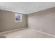 Cozy basement room with neutral-toned walls, tile flooring, and a window providing natural light and fresh air at 3222 Bayview Dr, Jonesboro, GA 30236