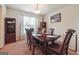 Elegant dining room with a large wooden table and a window for natural light at 7163 Walton Reserve Ln, Austell, GA 30168