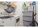 Well-organized laundry room featuring a washer, dryer, and storage shelves at 7163 Walton Reserve Ln, Austell, GA 30168