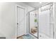 Bright bathroom with a hard surface floor, glass shower enclosure, and linen closet at 755 Gelderland Dr, Hampton, GA 30228