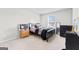 Cozy bedroom with black bed frame, side tables, and window view at 755 Gelderland Dr, Hampton, GA 30228