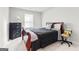 Bedroom features dark wood bed frame, side table and view from large window at 755 Gelderland Dr, Hampton, GA 30228