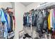 Organized walk-in closet with ample hanging space, shelving, and floor storage at 755 Gelderland Dr, Hampton, GA 30228