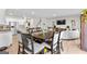Open-concept dining room with a modern table and seating, adjacent to the kitchen and living area at 755 Gelderland Dr, Hampton, GA 30228