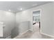 Bright upstairs hallway with carpet and neutral walls leads to a bedroom with natural lighting at 755 Gelderland Dr, Hampton, GA 30228