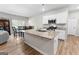 Modern kitchen with stainless steel appliances, granite countertops, and an island with sink at 755 Gelderland Dr, Hampton, GA 30228