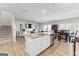 Bright, open kitchen with white cabinets, stainless steel appliances, and a granite island at 755 Gelderland Dr, Hampton, GA 30228