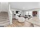 Spacious living area featuring a staircase, fireplace, comfortable seating, and contemporary decor at 755 Gelderland Dr, Hampton, GA 30228
