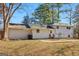 Backyard with mature trees, home exterior and patio, with ample space for entertaining at 6071 Cristie Dr, Ellenwood, GA 30294