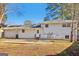 Backyard view of home showcasing exterior features, patio, and spacious yard at 6071 Cristie Dr, Ellenwood, GA 30294