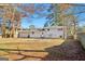Spacious backyard featuring mature trees, a patio, and a home exterior view at 6071 Cristie Dr, Ellenwood, GA 30294