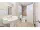 Bright bathroom featuring a pedestal sink, tiled floor, and a shower-tub combo at 6071 Cristie Dr, Ellenwood, GA 30294