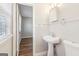 The charming bathroom features a pedestal sink, complemented by beadboard paneling and bright lighting at 6071 Cristie Dr, Ellenwood, GA 30294