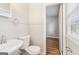 Bright bathroom featuring a pedestal sink and wood-look floors at 6071 Cristie Dr, Ellenwood, GA 30294