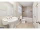 Neutral bathroom with a pedestal sink, tiled floor, and a shower-tub combo at 6071 Cristie Dr, Ellenwood, GA 30294