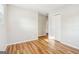 A bright bedroom with wood-look flooring and neutral paint creates a versatile and stylish space at 6071 Cristie Dr, Ellenwood, GA 30294