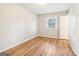 Bedroom featuring a window, closet, and light-colored wood-look floors at 6071 Cristie Dr, Ellenwood, GA 30294