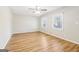 Bright bedroom with wood-look floors, two windows, and a ceiling fan creating a cozy atmosphere at 6071 Cristie Dr, Ellenwood, GA 30294