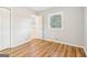 A bright bedroom features wood-look flooring, window, and closet, for a functional and stylish space at 6071 Cristie Dr, Ellenwood, GA 30294