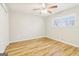 Bright bedroom featuring a ceiling fan, window and light-colored wood-look floors at 6071 Cristie Dr, Ellenwood, GA 30294