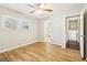 A bright bedroom with wood-look flooring, two windows, and ceiling fan that adds comfort and style at 6071 Cristie Dr, Ellenwood, GA 30294