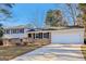 The exterior of this house features a convenient attached two-car garage and a spacious driveway at 6071 Cristie Dr, Ellenwood, GA 30294
